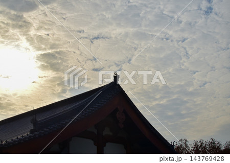 Close-up of the ornate decor on the Chinese classic roof of traditional building, Chinese architecture in China. Chinese folk religion landmark. Buddhist Temple or traditional building. Close-up of the ornate decor on the Chinese classic roof of traditional building, Chinese architecture in China. Chinese folk religion landmark. Buddhist Temple or traditional building. 143769428
