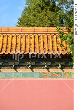 Close-up of the ornate decor on the Chinese classic roof of traditional building, Chinese architecture in China. Chinese folk religion landmark. Buddhist Temple or traditional building. Close-up of the ornate decor on the Chinese classic roof of traditional building, Chinese architecture in China. Chinese folk religion landmark. Buddhist Temple or traditional building. 143769441