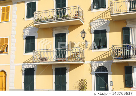 Ligurian architecture facade shutters Italy. Historical heritage preservation authentic style. Mediterranean travel destination design guide. Ligurian architecture facade shutters Italy. Historical heritage preservation authentic style. Mediterranean travel destination design guide. 143769637