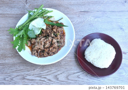 Thai spicy chop beef meat salad with fresh vegetable on plate eat couple sticky rice 143769701