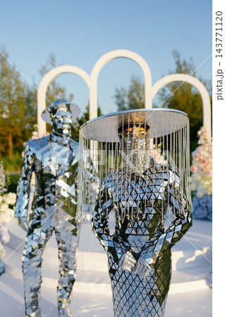 Mirror man performing with reflective prop at event 143771120
