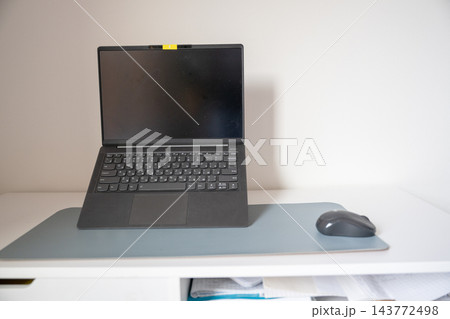 Laptop computer with wireless mouse on minimalist home office desk with copy space 143772498