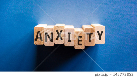 Anxiety word symbol. Concept word Anxiety on beautiful wooden blocks. Beautiful blue background. Business medical anxiety word concept. Copy space. Anxiety word symbol. Concept word Anxiety on beautiful wooden blocks. Beautiful blue background. Business medical anxiety word concept. Copy space. 143772852