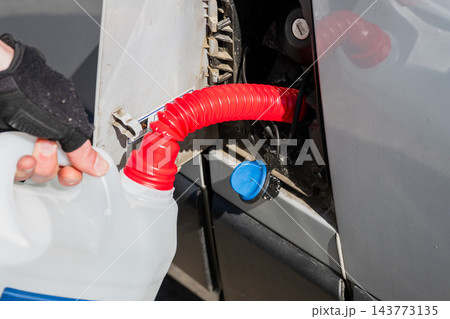 Refilling campervan fresh water tank from portable water container using flexible funnel 143773135