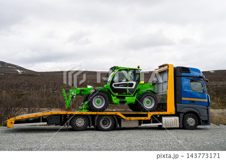 Telehandler loaded on flatbed truck in remote arctic landscape of Finnish Lapland 143773171