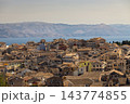 Old town rooftops overlooking sea and mountains Old town rooftops overlooking sea and mountains 143774855