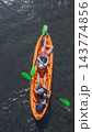 Top view of people paddling orange kayak Top view of people paddling orange kayak 143774856