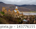 Ananuri Fortress complex with towers, churches and blossoming trees above reservoir in spring, Georgia 143776155