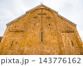 Carved stone cross on golden church gable at Ananuri Fortress, low angle, Georgia 143776162