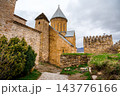 Ananuri church with conical roof, watchtower and cobblestone path in fortress, Georgia 143776166