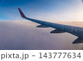 Beautiful salmon dawn and the wing of an airplane above the clouds. 143777634