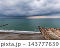 Seascape with rain in the distance. Thick clouds over the sea. 143777639