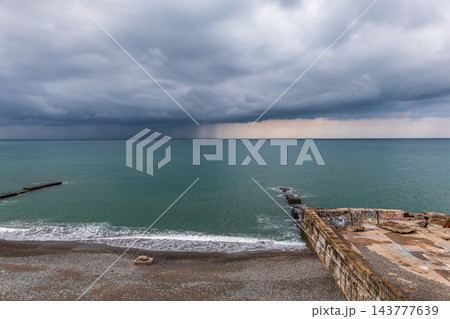 Seascape with rain in the distance. Thick clouds over the sea. 143777639