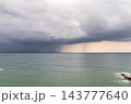 Seascape with rain in the distance. Thick clouds over the sea. 143777640
