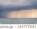 Seascape with rain in the distance. Thick clouds over the sea. 143777641