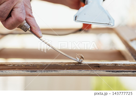 Carpenter at work, restoring an old wooden window. Carpentry. 143777725