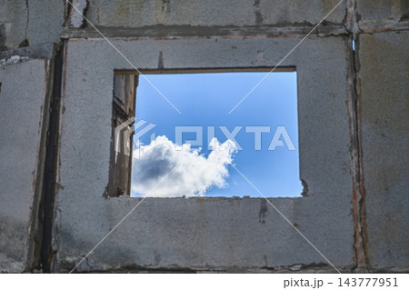 Blue Sky and Clouds Through Destroyed Apartment Window After Russian Airstrike in Ukraine Blue Sky and Clouds Through Destroyed Apartment Window After Russian Airstrike in Ukraine 143777951