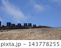 Helicopters flies on construction site of vertically mounted photovoltaic plant, solar panels, future innovation energy concept 143778255