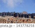 Helicopters flies on construction site of vertically mounted photovoltaic plant, solar panels, future innovation energy concept 143778258