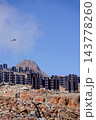 Helicopters flies on construction site of vertically mounted photovoltaic plant, solar panels, future innovation energy concept 143778260