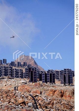 Helicopters flies on construction site of vertically mounted photovoltaic plant, solar panels, future innovation energy concept Helicopters flies on construction site of vertically mounted photovoltaic plant, solar panels, future innovation energy concept 143778260
