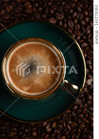 Fresh espresso cup with crema on coffee beans background 143778363