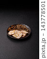 A bowl featuring slices of boiled chicken fillet, buckwheat noodles, and mushrooms 143778501