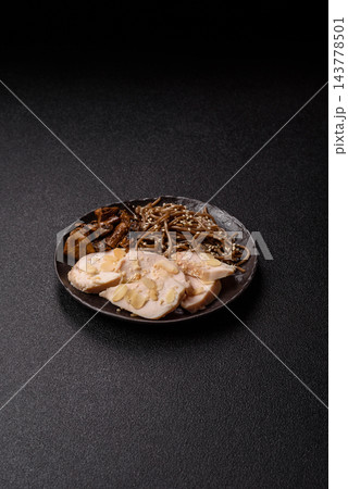 A bowl featuring slices of boiled chicken fillet, buckwheat noodles, and mushrooms 143778501