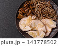 A bowl featuring slices of boiled chicken fillet, buckwheat noodles, and mushrooms 143778502