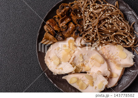 A bowl featuring slices of boiled chicken fillet, buckwheat noodles, and mushrooms 143778502