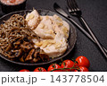 A bowl featuring slices of boiled chicken fillet, buckwheat noodles, and mushrooms 143778504