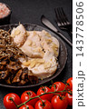 A bowl featuring slices of boiled chicken fillet, buckwheat noodles, and mushrooms 143778506