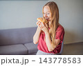 Woman enjoying pan de muerto during a Mexican seasonal food experience. 143778583