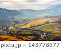 rural fields near Borzhava Mountains in autumn time landscape. beautiful view of agricultural area. gorgeous mountain ridge with rolling hills. cloudy sky rural fields near Borzhava Mountains in autumn time landscape. beautiful view of agricultural area. gorgeous mountain ridge with rolling hills. cloudy sky 143778677