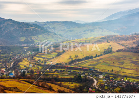 rural fields near Borzhava Mountains in autumn time landscape. beautiful view of agricultural area. gorgeous mountain ridge with rolling hills. cloudy sky 143778677