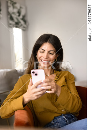 Woman messaging, browsing social media or checking notifications on smartphone 143779627