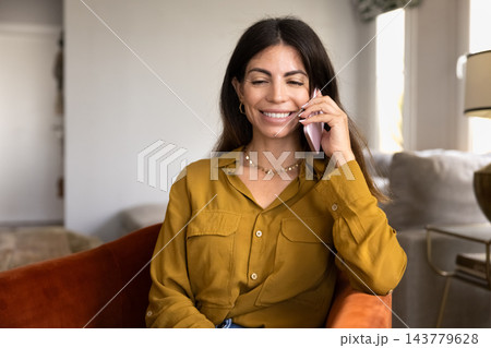 Smiling woman having mobile call, talking on smartphone at home 143779628