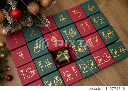 Christmas advent calendar with numbered gift boxes and a hidden holiday surprise Christmas advent calendar with numbered gift boxes and a hidden holiday surprise 143779746