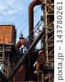 Vertical photo of historic blast furnace steel framework with massive rusty gas pipelines skip hoist bridge brick housing and multi level catwalk stairs in Duisburg Ruhr region Westphalia Germany 143780261