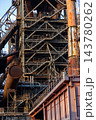 Vertical photo of historic blast furnace steel framework with massive rusty gas pipe skip hoist bridge conical exhaust stack and multi tier stairs in Duisburg Ruhr region Westphalia Germany 143780262