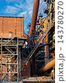 Vertical photo of historic blast furnace steel framework with brick building housing massive rusty gas pipeline skip hoist bridge and stairs in Duisburg Ruhr region Westphalia Germany 143780270