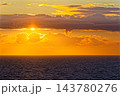 Golden sunset over calm ocean with low clouds 143780276