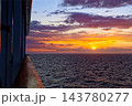 Sunset over open sea viewed from ship rail 143780277
