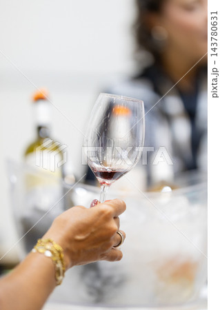 Wine taster holding a glass during a red wine tasting 143780631