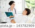 Female doctor communicates with male patients in cosmetology clinic before surgery 143782909