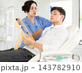 Man sits in chair at a doctor appointment with beautician. Woman doing facial examination before surgery 143782910