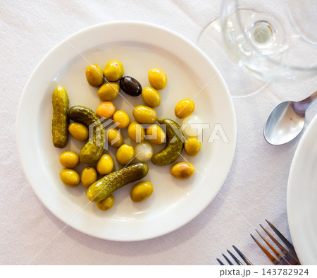 Green olives served with cucumber and onion on plate Green olives served with cucumber and onion on plate 143782924