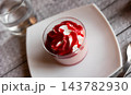 Sweet dessert strawberry mousse whipped to delicate foam is served in small bowl for breakfast. 143782930