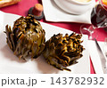 Baked artichokes 143782932