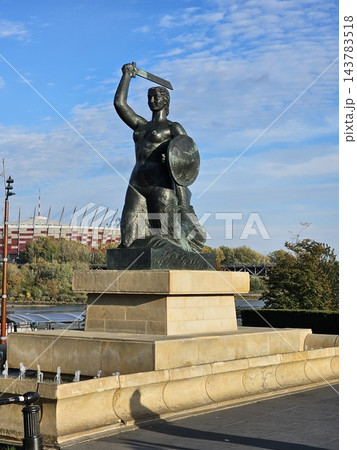 Warsaw, Poland - October 5, 2026: Historic mermaid sculpture overlooking Vistula promenade Warsaw, Poland - October 5, 2026: Historic mermaid sculpture overlooking Vistula promenade 143783518